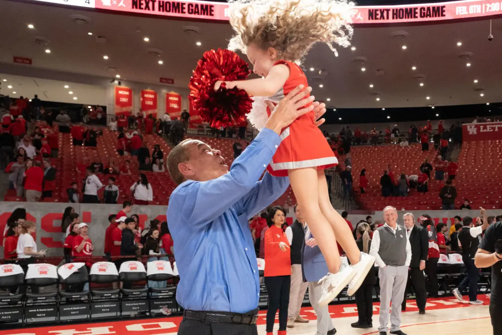 UH coach Kelvin Sampson gave his granddaughter Maisy Jade a fun ride after Houston's comeback win over Cincinnati. (Photo by F. Carter Smith)