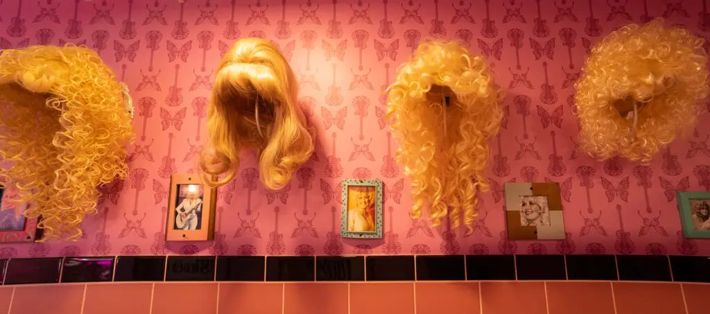 The ladies room is filled with Dolly Parton wigs and photos.