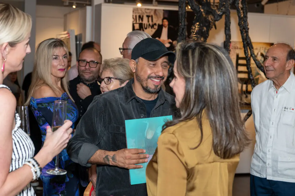 Amador Montes shares a candid moment in front of the Tipula sculpture at the Art of the World Gallery with co-founder Liliana Molina at the artist’s “Under the Skin” solo exhibition. (Photo by Paul R. Davis)