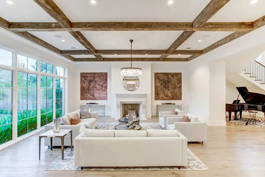 An open floor plan with elevated wood flooring and beams in 5554 Longmont Drive by Sims Luxury Builders created the perfect mix when Moni sold this property in 2021. (Photo TK Images)