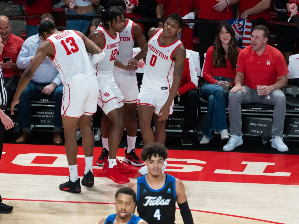 University of Houston players J'Wan Roberts, Tramon Mark, Jamal Shead and Marcus Sasser are always having fun. And UH quarterback record shatterer Case Keenum and his wife Kimberly enjoyed the show this night at Fertitta Center. (Photo by F. Carter Smith)
