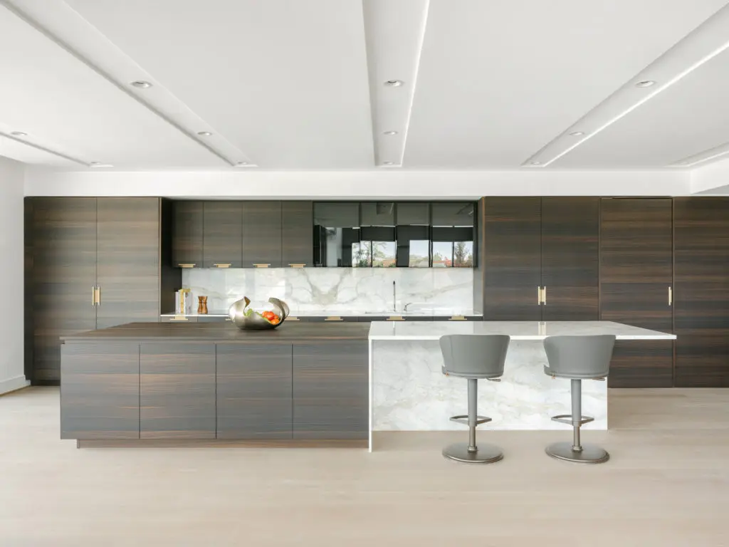 The kitchen in the CASA Companies condo are camouflaged behind beautiful Italian wood paneling. (Photo by Divya Pande)
