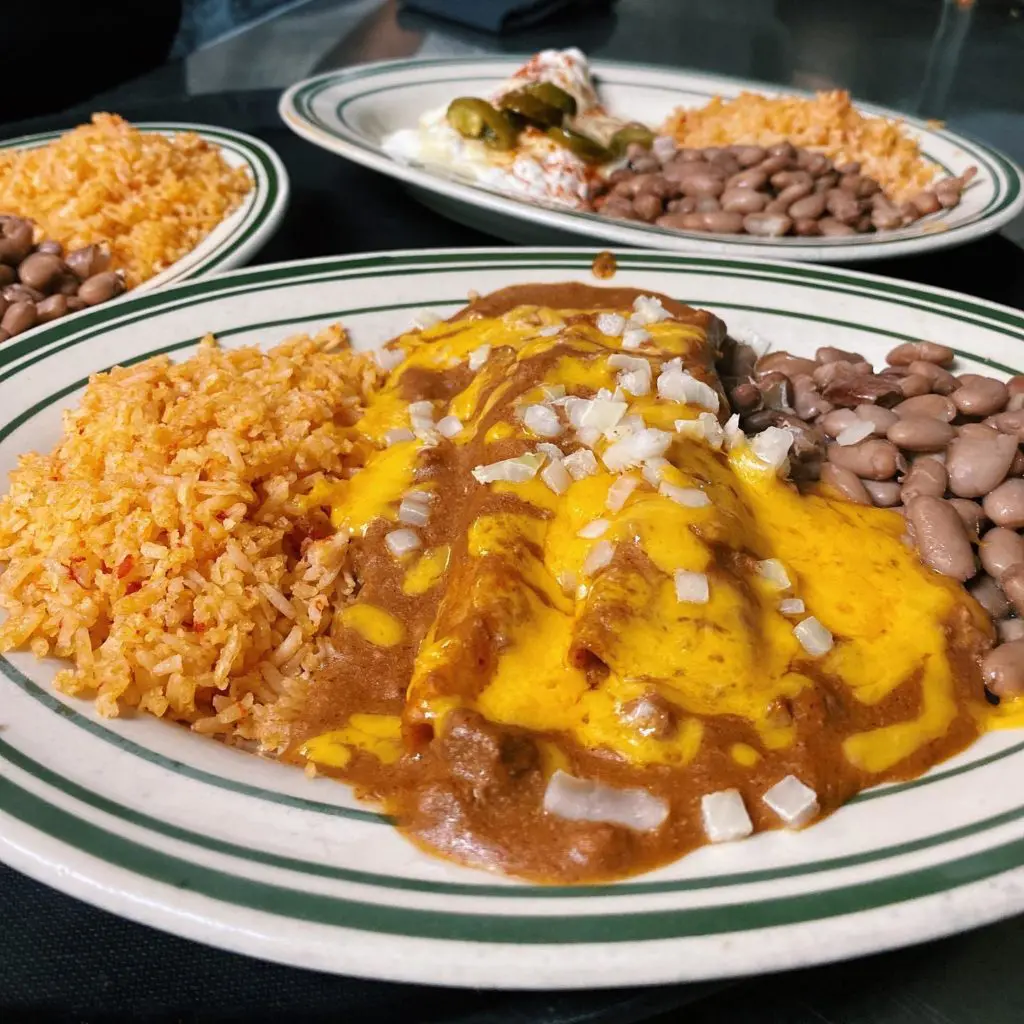 The Original - cheese enchiladas con carne topped with raw onion.
