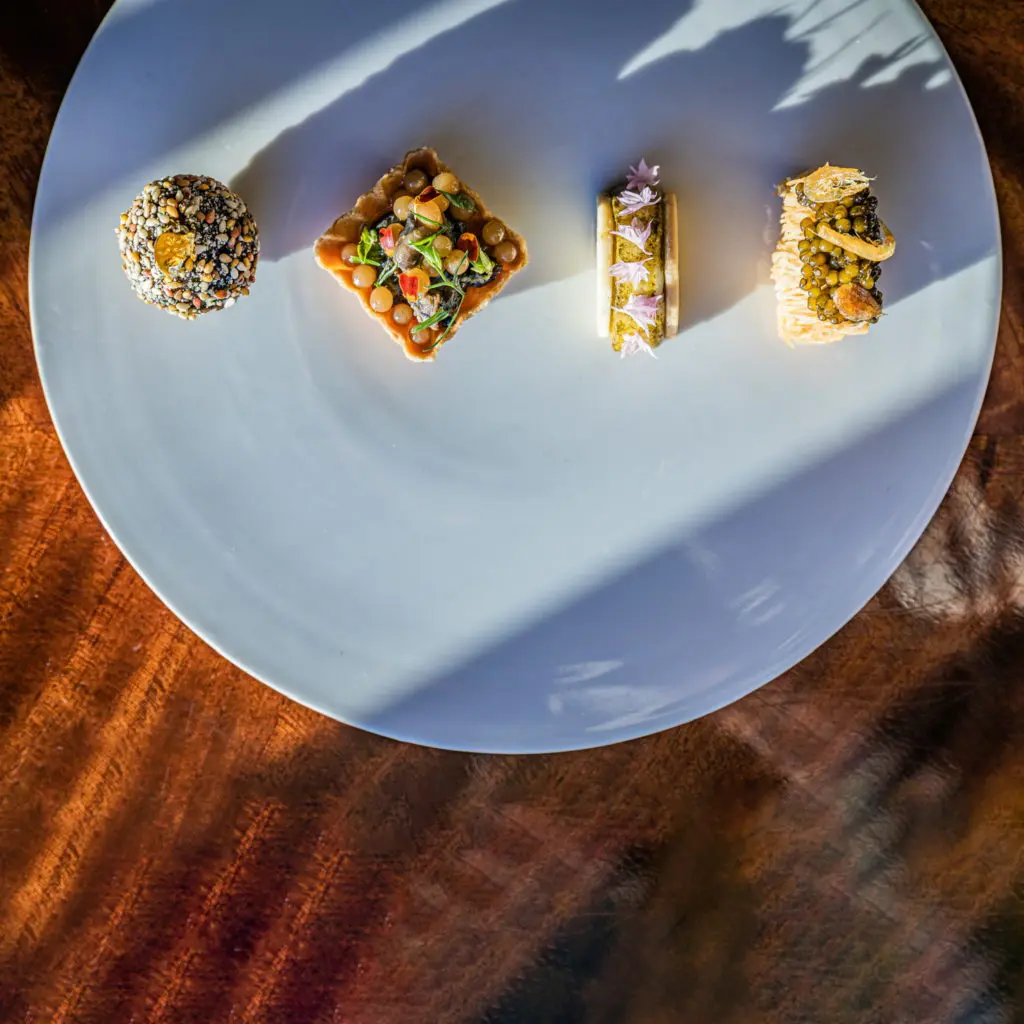 The Greek Tile sampler at March Lounge brings a lot to the table. Left to Right: Loukoumas and foie gras; olive oil & escargot; grape and halloumi; kataifi and shrimp. (Photo by Zach Horst)