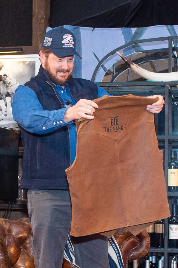 Cole Hauser, Yellowstone's Rip Wheeler, accepts a B&B The Ranch suede vest from restaurateur Ben Berg. (Photo by Jacob Power)