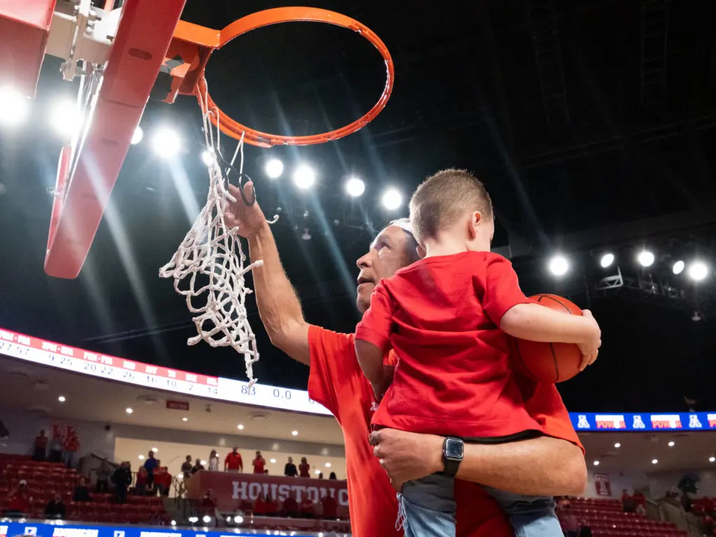 UH coach Kelvin Sampson brought his grandson Kylen up on the ladder with him to cut down the net.  (Photo by F. Carter Smith)