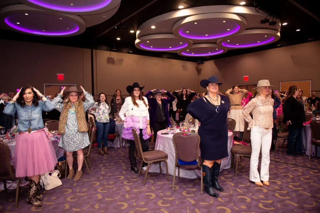 Guests play a quick game of heads or tails a the Down syndrome benefit.