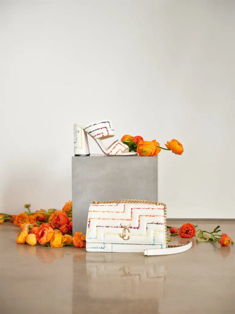 Both Jimmy Choo signatures, the Varenne Avenue shoulder bag, and the Themis Sandal 100 are enriched with rainbow embroidery in the iconic matelassé pattern.