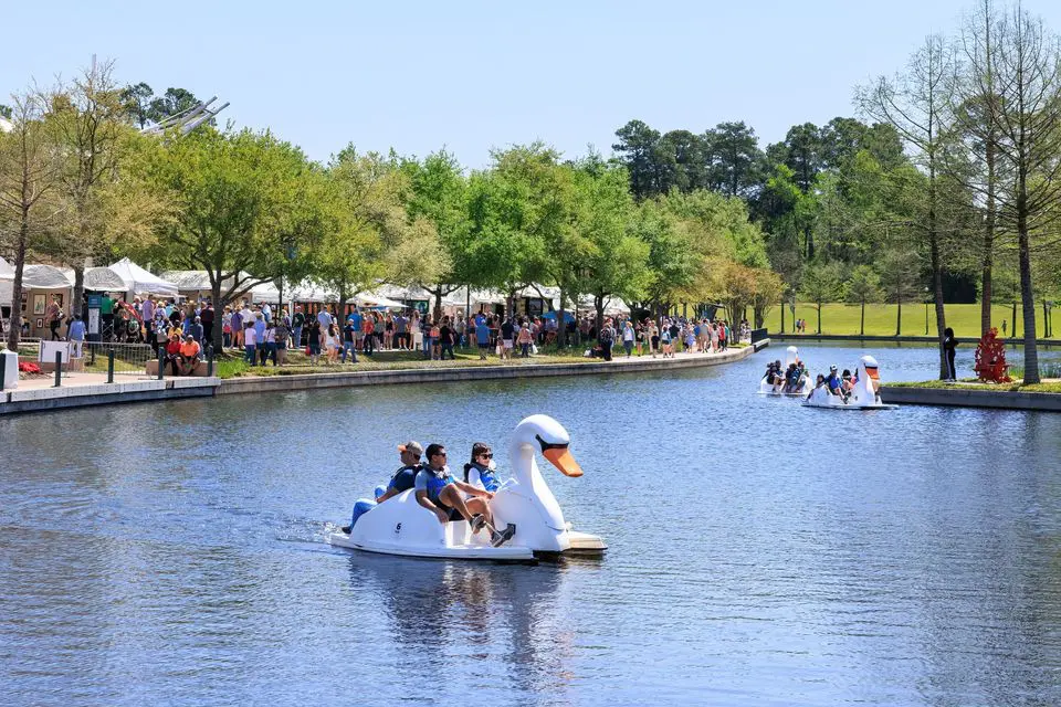 Festivalgoers enjoy paddle boats along the Waterway during the Woodlands Waterway Arts Festival. (Photo courtesy the Woodlands Waterway Arts Festival)