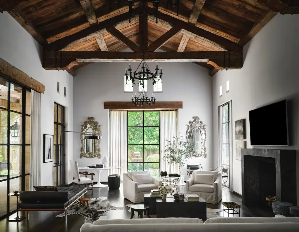 The family room with a Knoll Saarinen table and Barcelona chaise, and vintage furnishings including a pair of Venetian mirrors. (Photo by Douglas Friedman)
