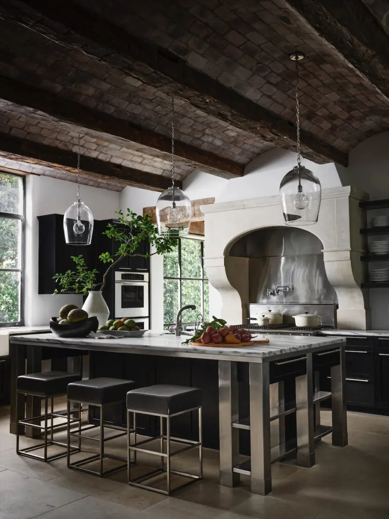 Dorsey lightened the kitchen’s barrel-vaulted brick ceiling and installed a custom stainless-steel island paired with barstools from American Leather. (Photo by Douglas Friedman)
