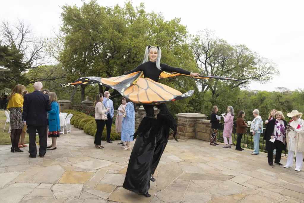 A butterfly stilt walker welcomes guests at the Fort Worth Garden Club Evening in the Garden. (Photo by Ellman Photography)