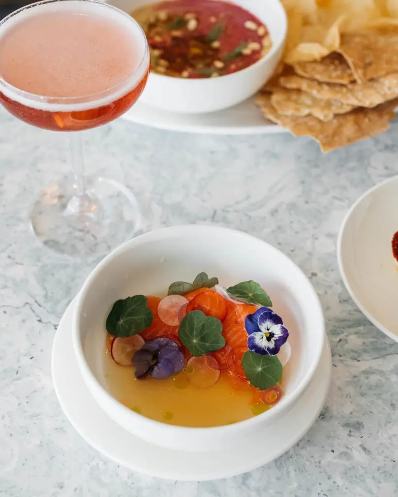 The salmon crudo at Coupes comes with radish and pickled fresno. (Courtesy)