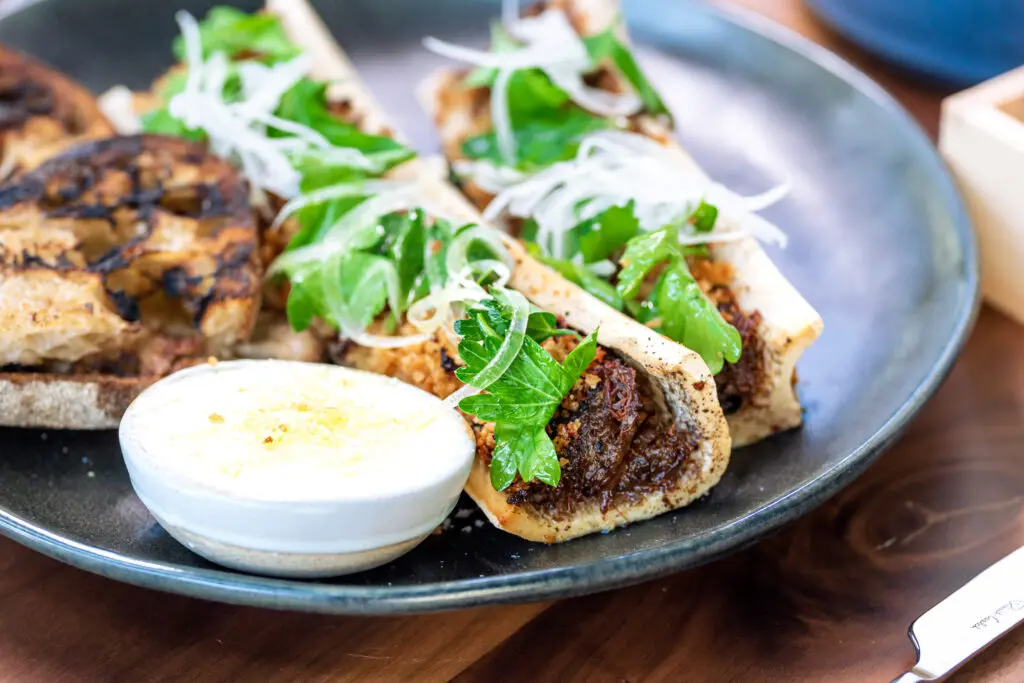 The bone marrow app is one of the sharable plates that Muse exec chef E.J. Miller is particularly pleased with. (Photo by Adrian Barboza and Dylan McEwan)