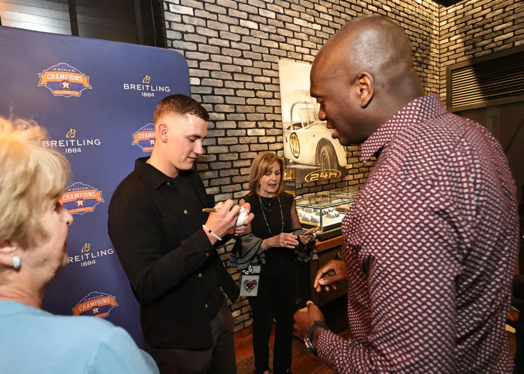Hunter Brown signs a baseball during the grand opening of the new Breitling store. (Photo by Bob Levey/Getty Images for Breitling)