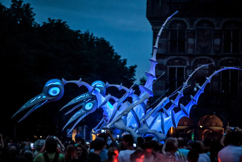Close-Act Theatre’s "Birdmen" come to life as large, dinosaur-like performers.
