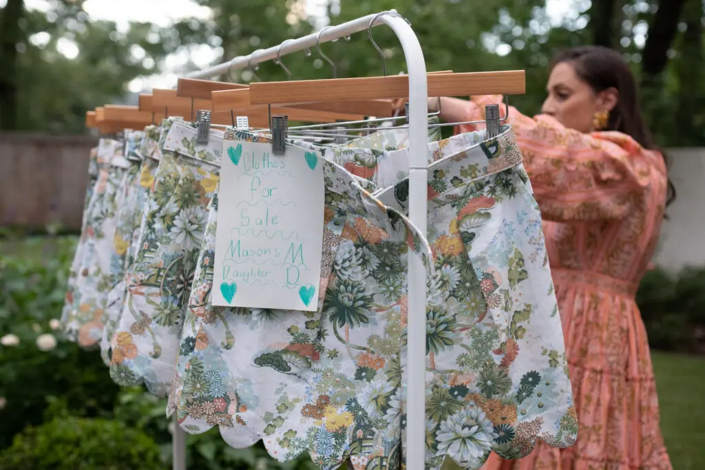 The Zorich kids + friends enjoyed creating signage for the on-sale clothing racks. 
(Photo by Lance Blade)