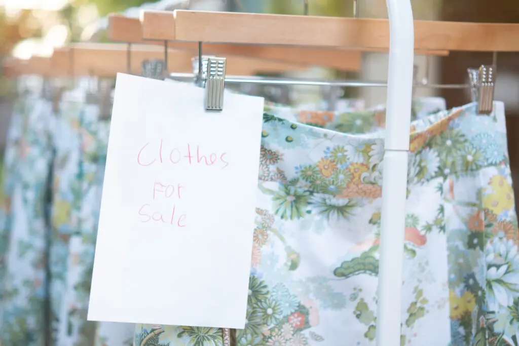 The Zorich kids + friends enjoyed creating signage for the on-sale clothing racks. 
(Photo by Lance Blade)