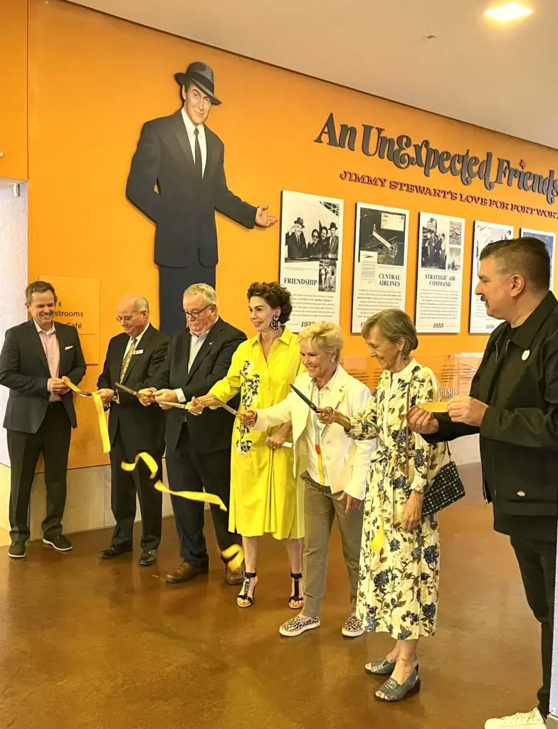 Jimmy Stewart exhibit opens at Fort Worth Museum of Science and History. Ramona Bass, Debbie Johnson Head, and Jane Schlanker help with the ribbon cutting. (Photo by Courtney Dabney)