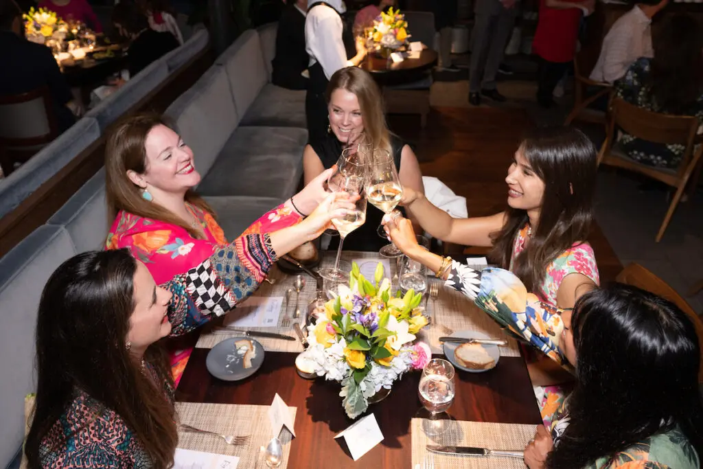 Cheers! Guests at Houston Ballet's Raising the Barre dinner fundraiser toast the tasty evening.  (Photo by Wilson Parish)