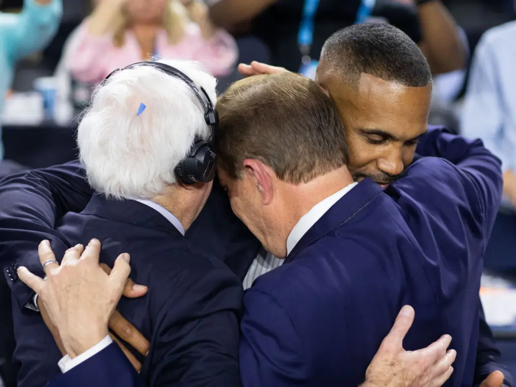 Bill Raftery, Jim Nantz and Grant Hill came together for a hug after Nantz's last basketball broadcast. (Photo by F. Carter Smith)