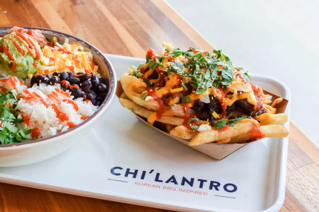 A rice bowl and the trademarked Original Kimchi Fries found at the new Houston outpost of Chi'Lantro BBQ.  (Photo by Photos courtesy of Chi'Lantro BBQ)
