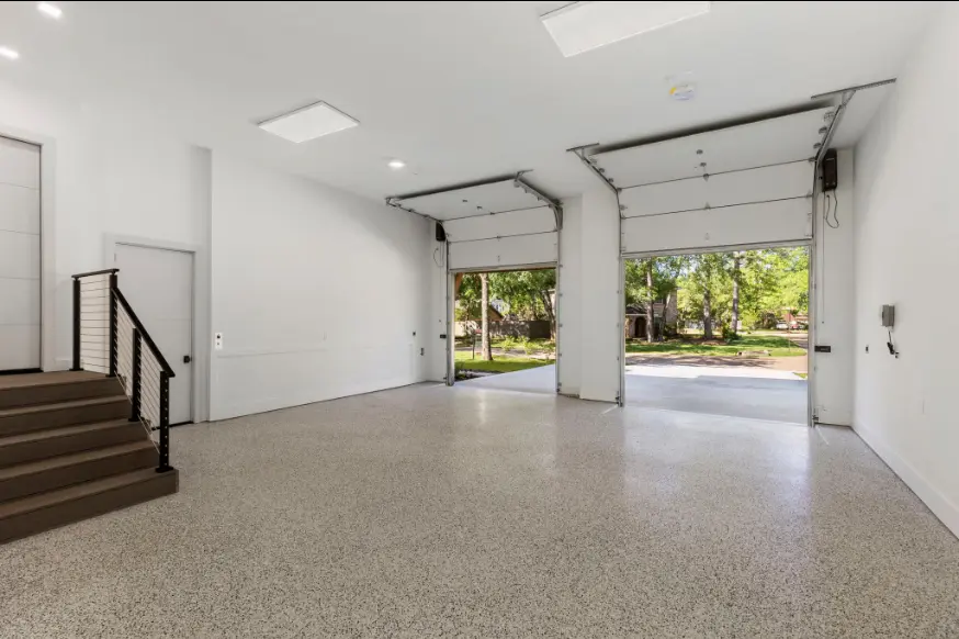 The garages at this Woodlands home have extended height in the ceilings and an epoxy floor.