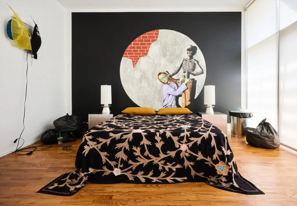 In a guest bedroom, a painting with a sculpture installation by Julien Ceccaldi. Custom nightstands. DWR pillows. Sconce by Jessi Reaves. (Photo by Jack Thompson)