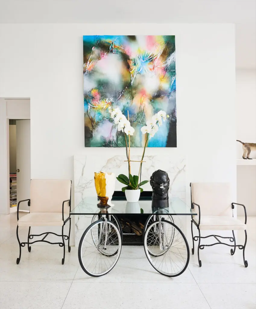 Painting by Leslie Martinez. Table by Gae Aulenti. Vessel by Gaetano Pesce, leather head by Nancy Grossman. Iron 1960s chairs from 1stDibs. (Photo by Jack Thompson)