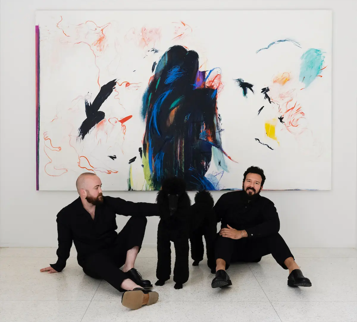 Cody Fitzsimmons, Christopher Scott, and their dog in their architecturally significant Houston townhome.