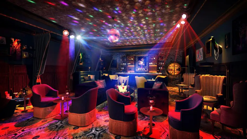 Hôtel Swexan's nightlife destination, Babous, features electric wall art and unique restrooms.