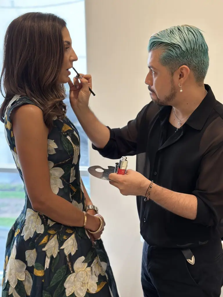 Mexico City based makeup artist Juan Peralta does a touch up on Best Dressed honoree Julia Longoria Chen.