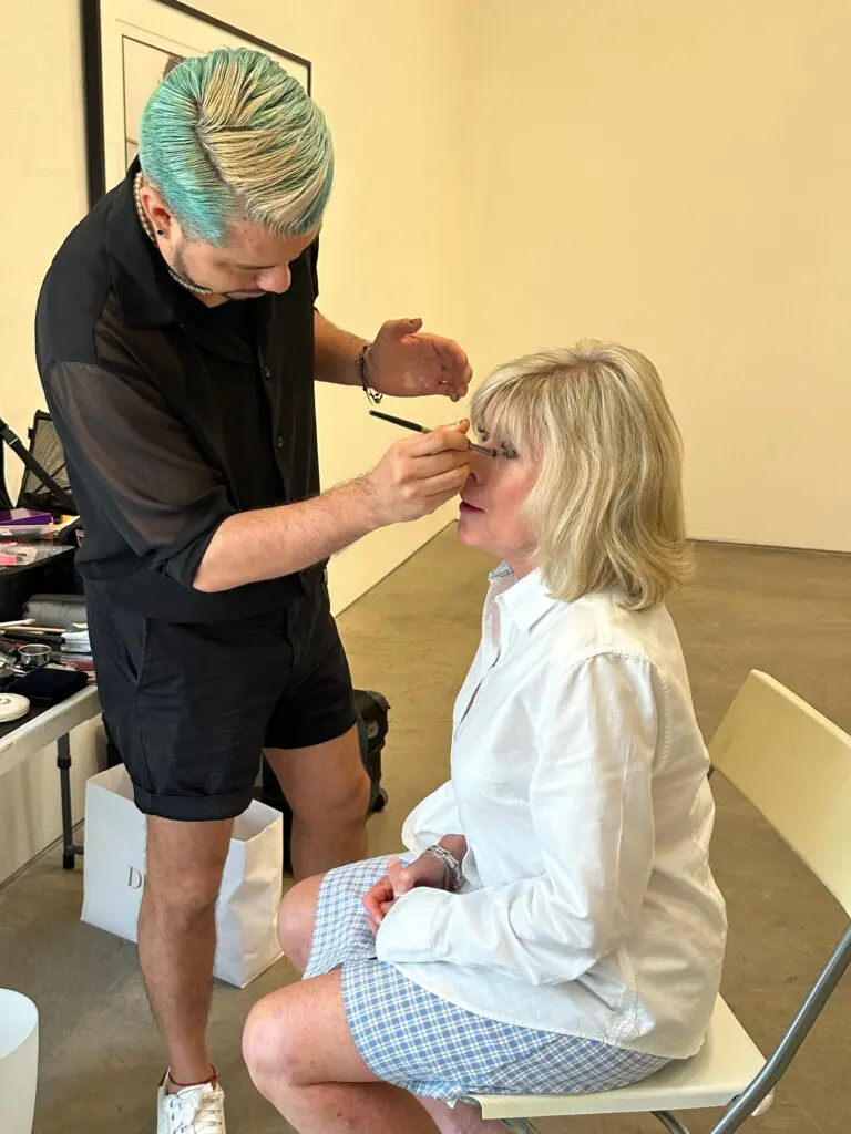 Makeup artist Juan Peralta works with Best Dressed honoree Zane Carruth at the PaperCity photo shoot.