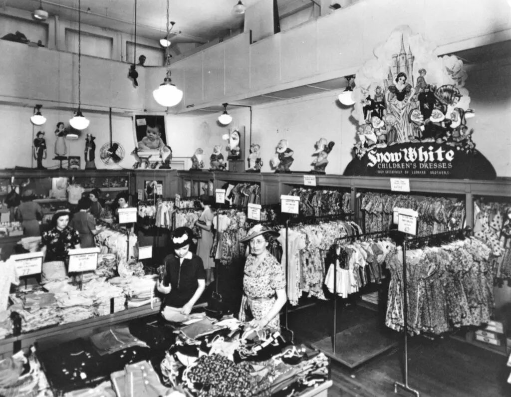 Shoppers peruse the children's department with Snow White looking on in the 1930s at Leonard's.