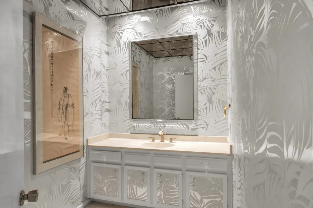 Silvered palms still sway in a guest bathroom.