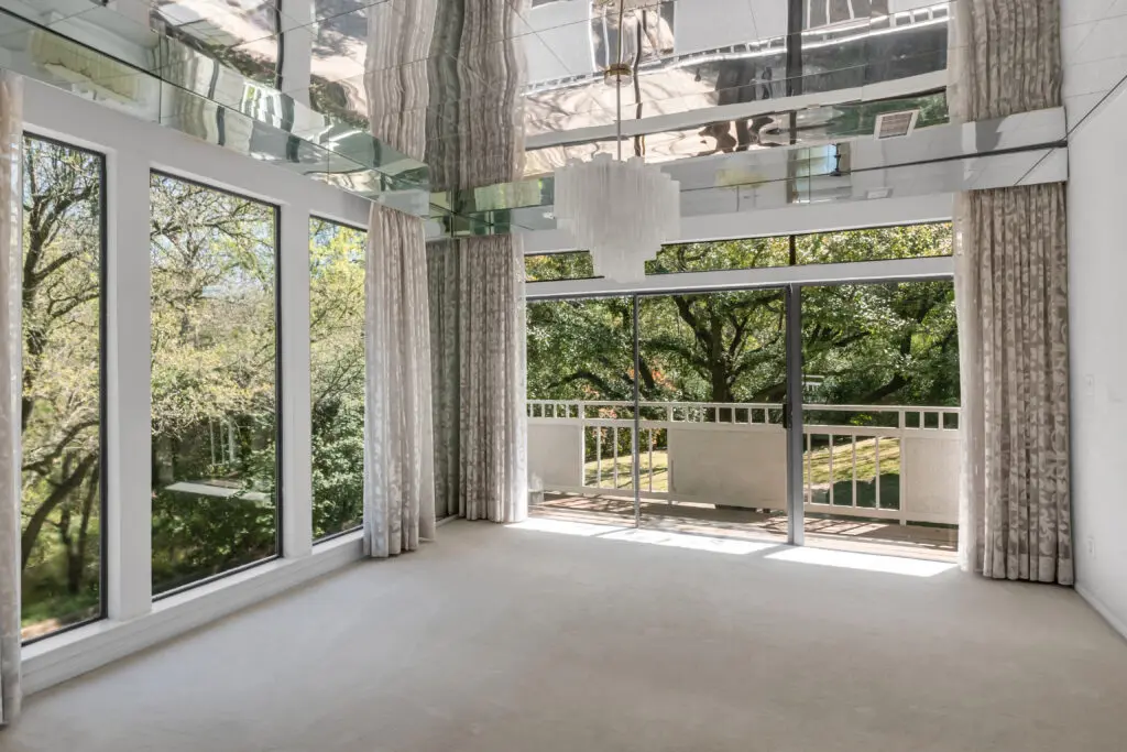 A peek at the mirrored ceiling in the dining room with its modern chandelier.