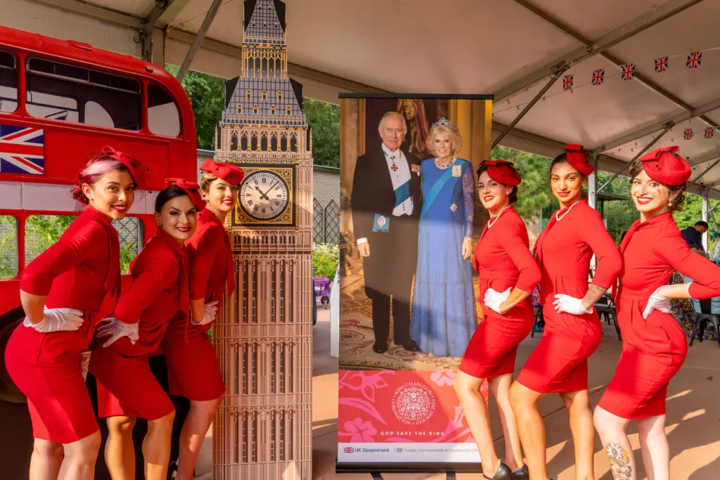The team from Marvelous Events flank colorful cutouts at the Houston Arboretum where invitation-only guests joined the celebration of the coronation of Britain's King Charles. (Photo by  Joffre Camacho, Square Foot Photography)