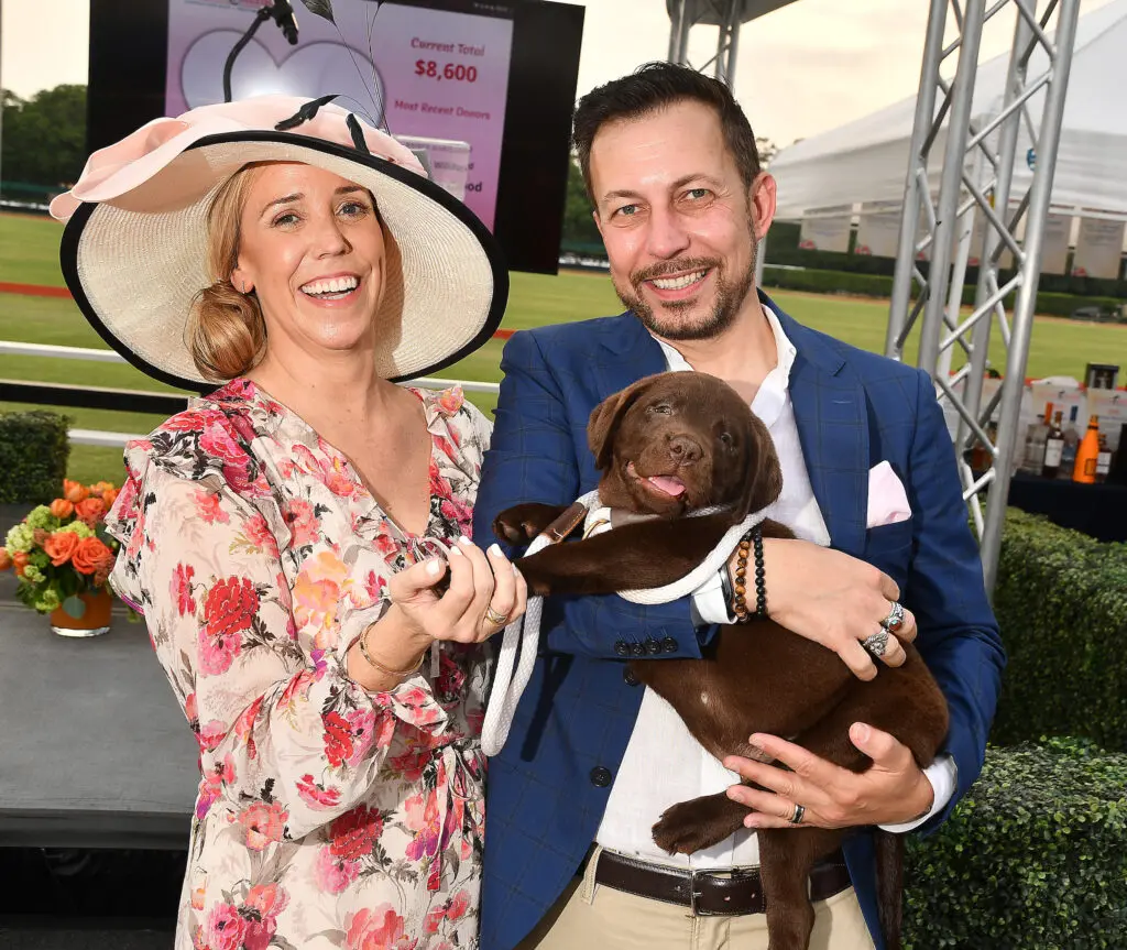 Silent auction winners of the puppy, Susan & Giulio Cattozzo at the Bo's Place Hats, Hearts & Horseshoes Kentucky Derby party at Houston Polo Club. (Photo by Dave Rossman)
