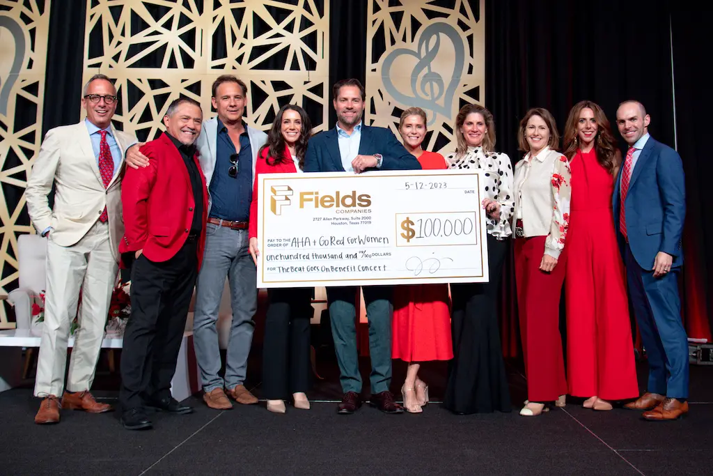 The Fields Companies presents its check to the American Heart Association Go Red for Women Luncheon featuring gospel-pop singer Amy Grant