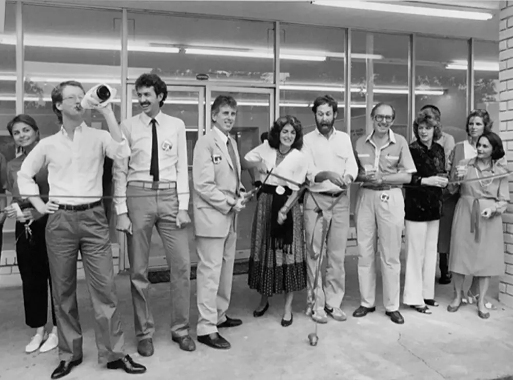 David Crossley, Sally Horrigan, and Paul Hester (at the center) and others at the ribbon cutting for the HCP building, 1983 (Courtesy David Crossley)