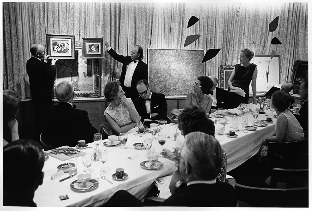 John de Menil, Jim Love, and Dominique de Menil (standing) at Art Investments, Ltd. dinner party to select art at the Ramada Club, Houston, 1965. (Courtesy the Menil Archives, the Menil Collection, Houston)