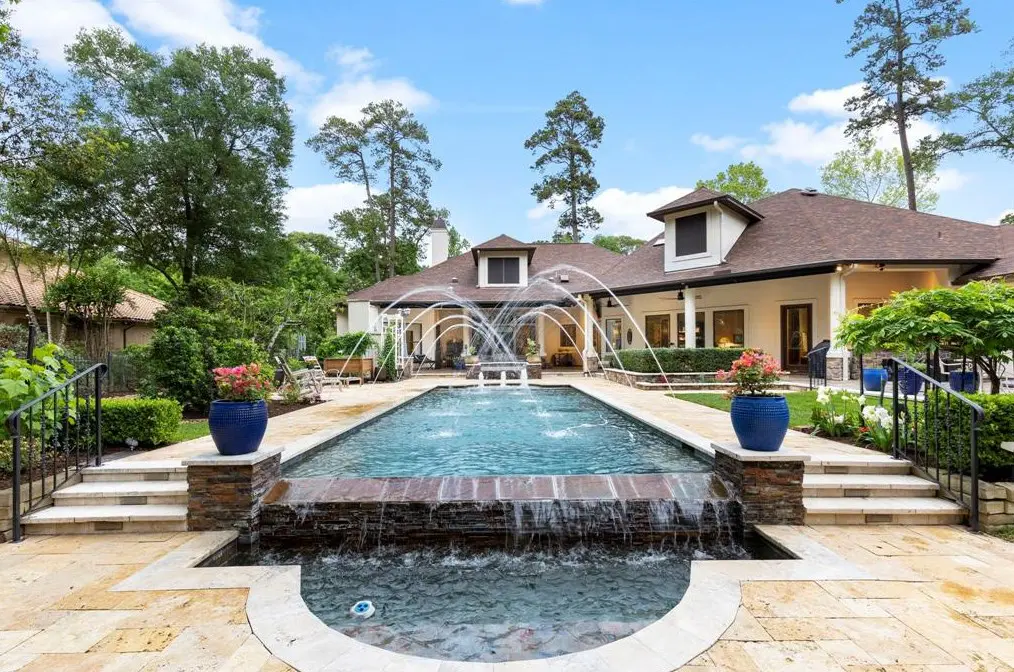 The sprawling 90 S Tranquil Path estate is part of the exclusive Grogan’s Point neighborhood. It also brings a Woodlands pool to swoon over.