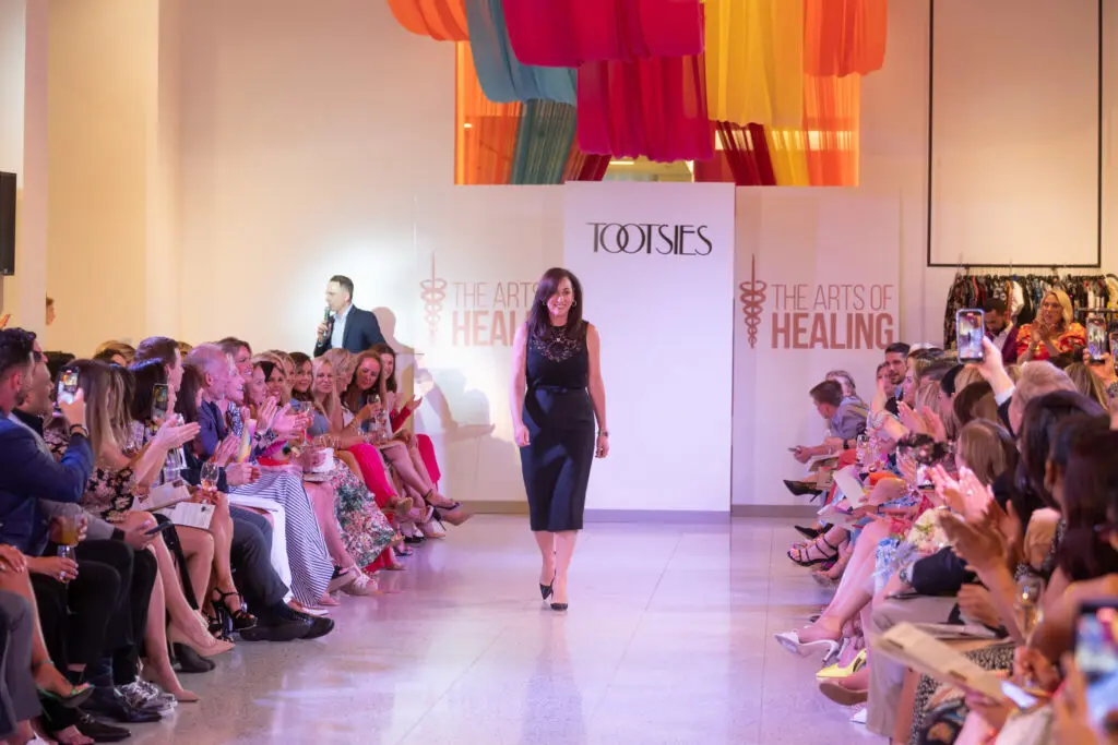 Amalia Stanton, Chief Strategic Communications and Marketing Officer at Memorial Hermann Health System, on the runway at The Arts of Healing Foundation's Women in Medicine fashion event (Photo by Daniel Ortiz)