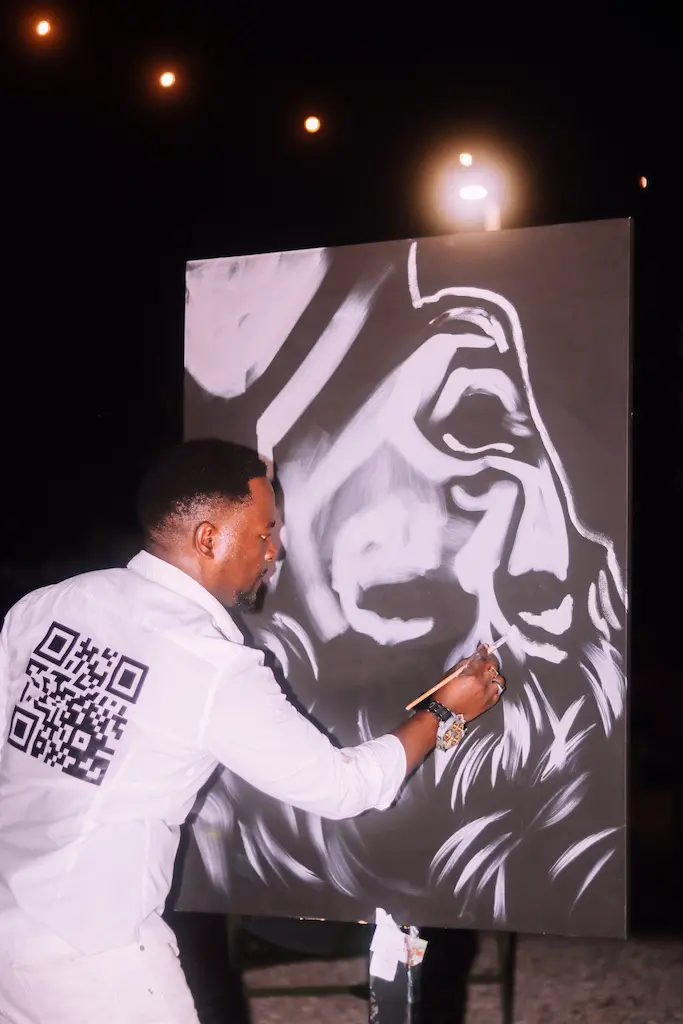 Artists Ange Hillz painting Tina Turner portrait at the SEBAS Foundation Live Fire Event  (Photo by AM Photography)