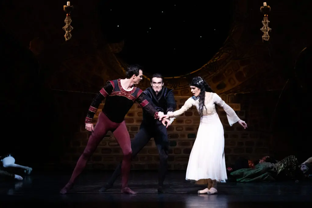 Houston Ballet Principals Beckanne Sisk as Odette and Chase O’Connell as Prince Siegfried with Corps de Ballet dancer Riley McMurray as Rothbart in Stanton Welch’s Swan Lake (Photo by Lawrence Elizabeth Knox. Courtesy of Houston Ballet)