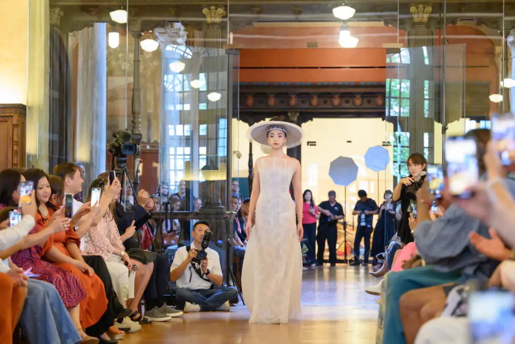 A white dress by Chloe Dao modeled by Gina Nguyen at the Ascend AAPI Spring Fashion Show (Photo by Ken Jones)