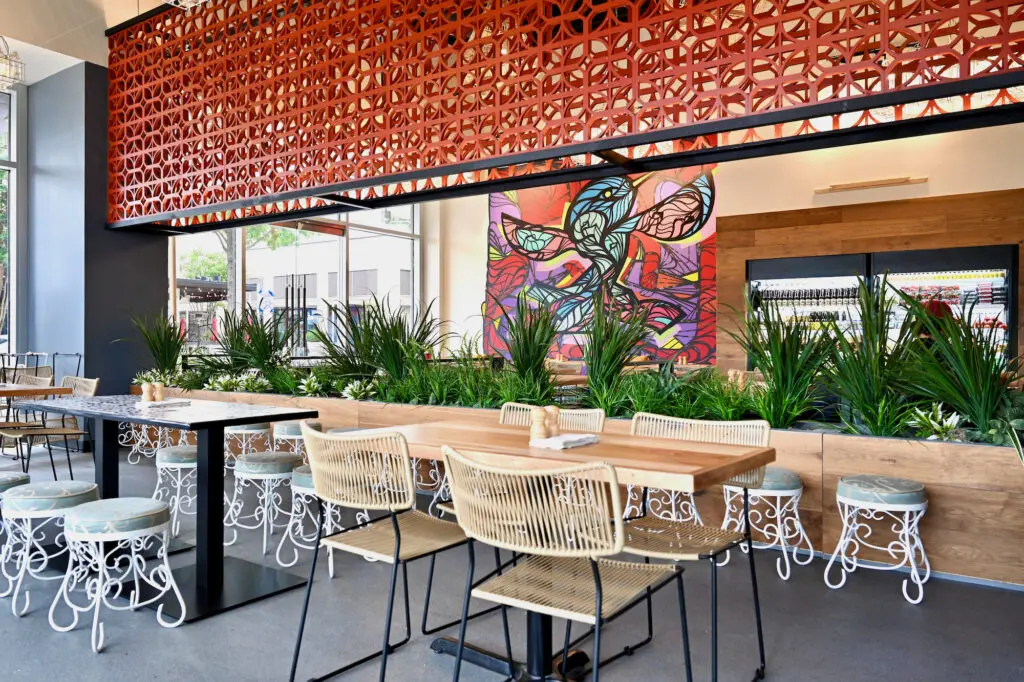 Most of the interior elements at Ojo de Aqua are imported from Mexico and many are created by Mexican artisans. Local Houston graffiti artist Daniel Anguilu created a color-splashed mural depicting the Texas state bird at Ojo’s entrance. (Photo by Alex Montoya)
