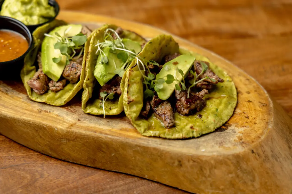 Ojo de Agua's rib eye tacos ($23) are marinated in a chimichurri sauce. (Photo by Jennifer Hasbún)