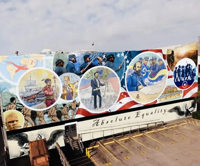 Houston-based painter Reginald C. Adams painted the 5,000-square-foot "Absolute Equality Mural" (2021) on the side of the Old Galveston Square building, located at 22nd and Strand in downtown Galveston. (Courtesy Reginald C. Adams and Visit Galveston)