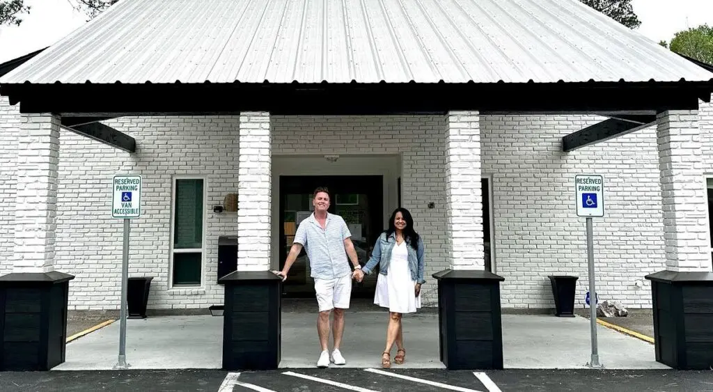 HeBrews Coffeehouse owners Geoffrey and Marsha Wood smile for a photo in front of their new location in The Woodlands. The couple already has a location in Magnolia and will be opening a location in Conroe in the near future. (Photo courtesy HeBrews Coffeehouse) 